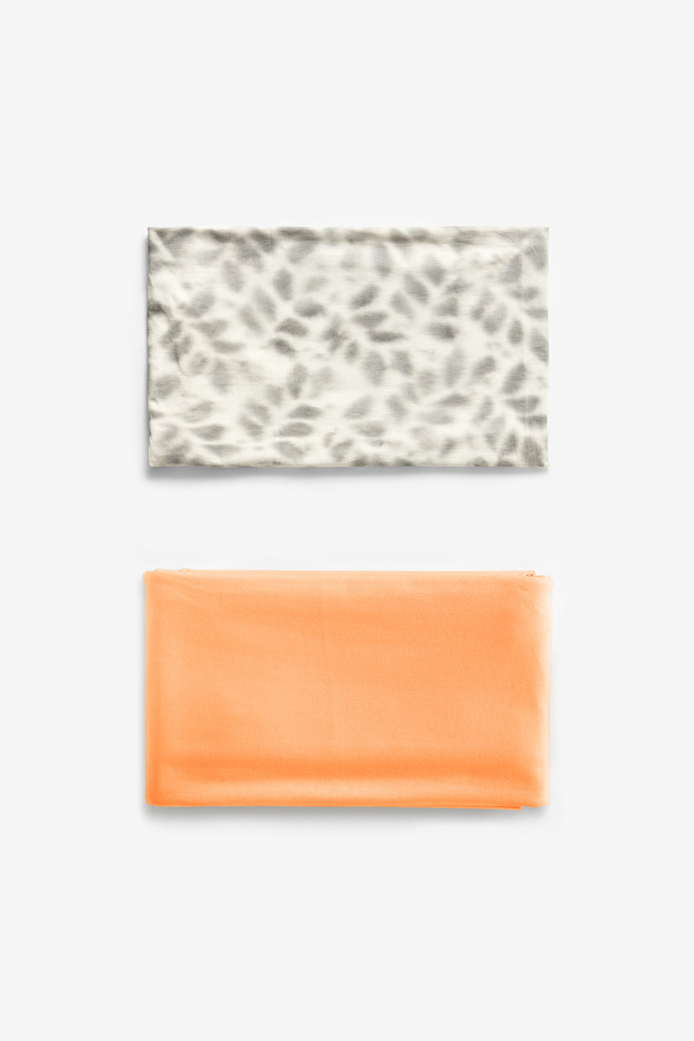 A folded bundle of Faded Bloomers fabric and Salmon fabric.