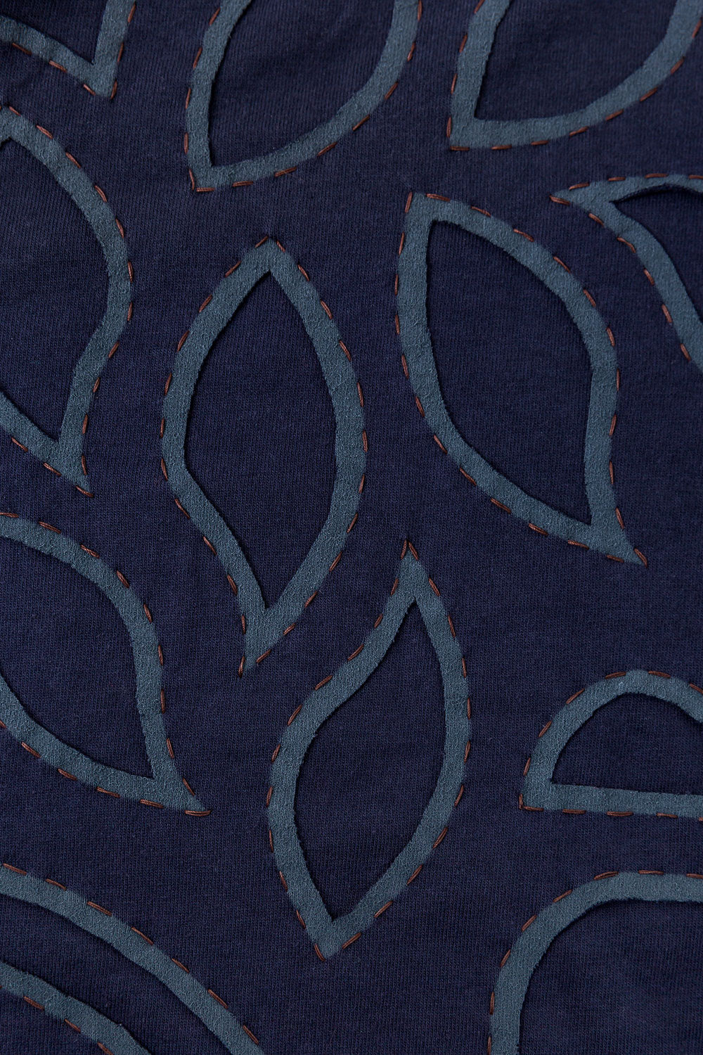 Swatch featuring the Abstract design in reverse appliqué on navy fabric.