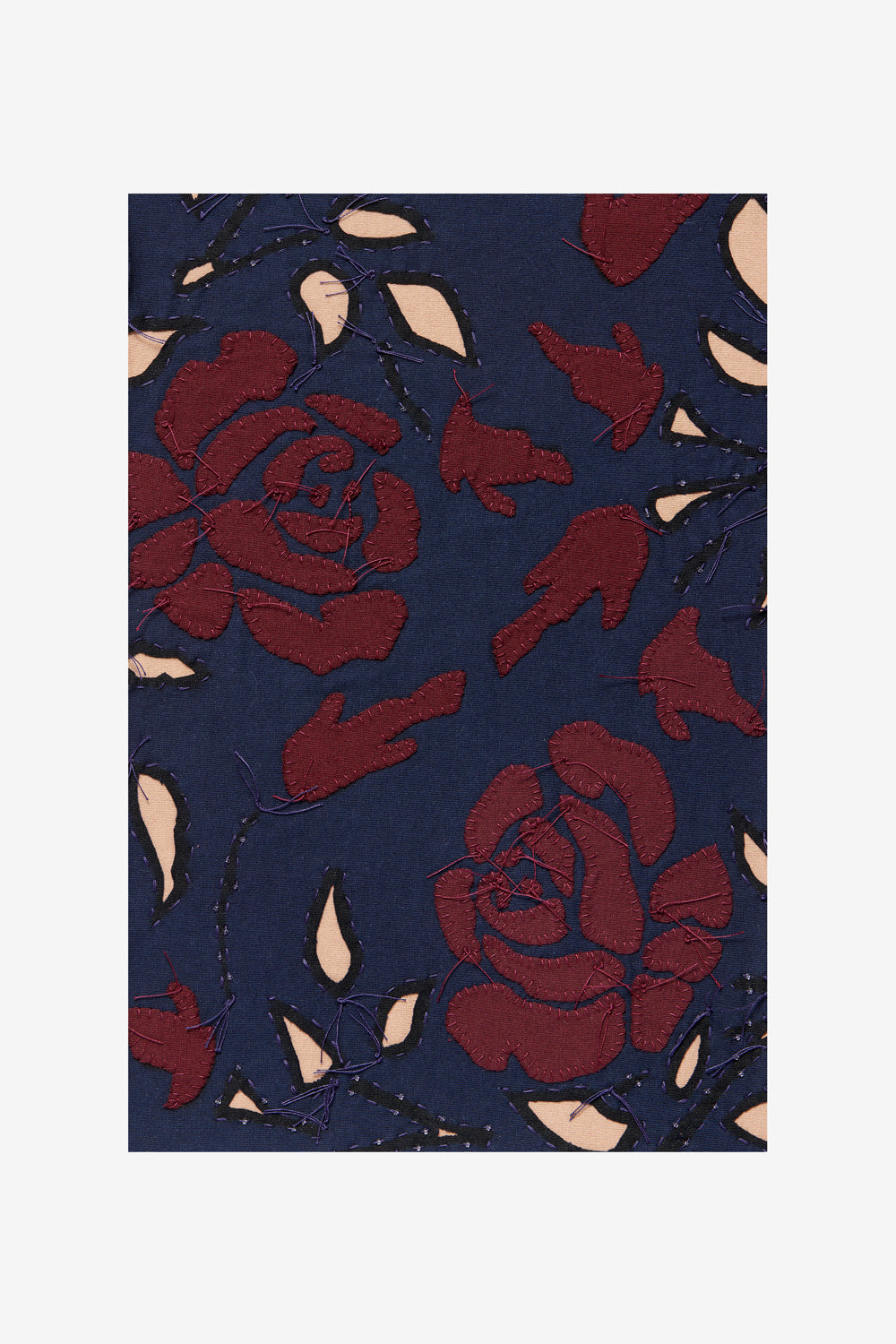 Fabric swatch featuring the Rose design with plum and ballet appliqué on navy fabric.