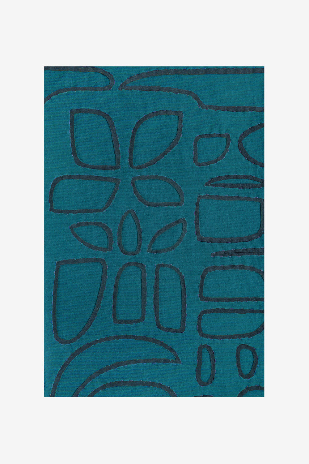 Fabric swatch with Tony stencil design in reverse appliqué on Teal fabric..