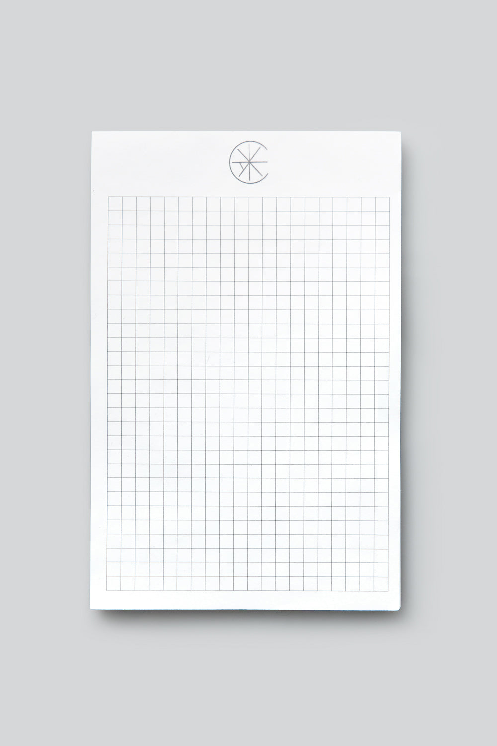 The School of Making grid notepad with wagon wheel logo.