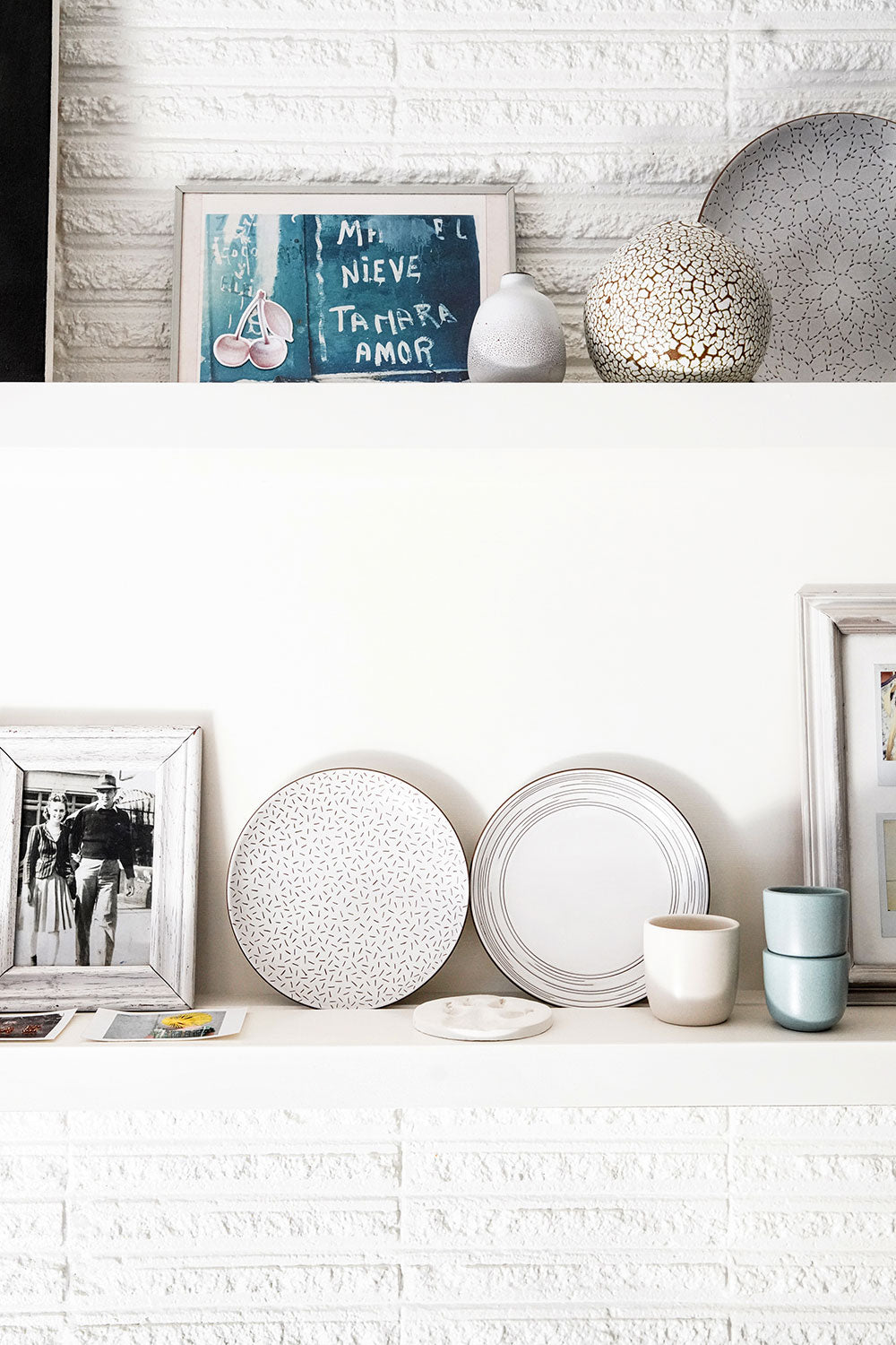 Echo Etched Salad Plate in Opaque White Hand Crafted from Alabama Chanin and Heath Ceramics Collaboration. Shown on fireplace mantel with other Heath Ceramics items.