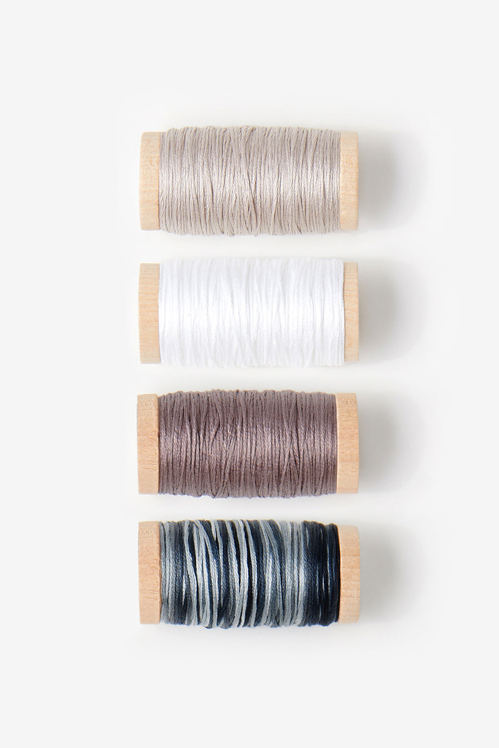 Floss bundle including silt, white, pewter, and variegated black floss.