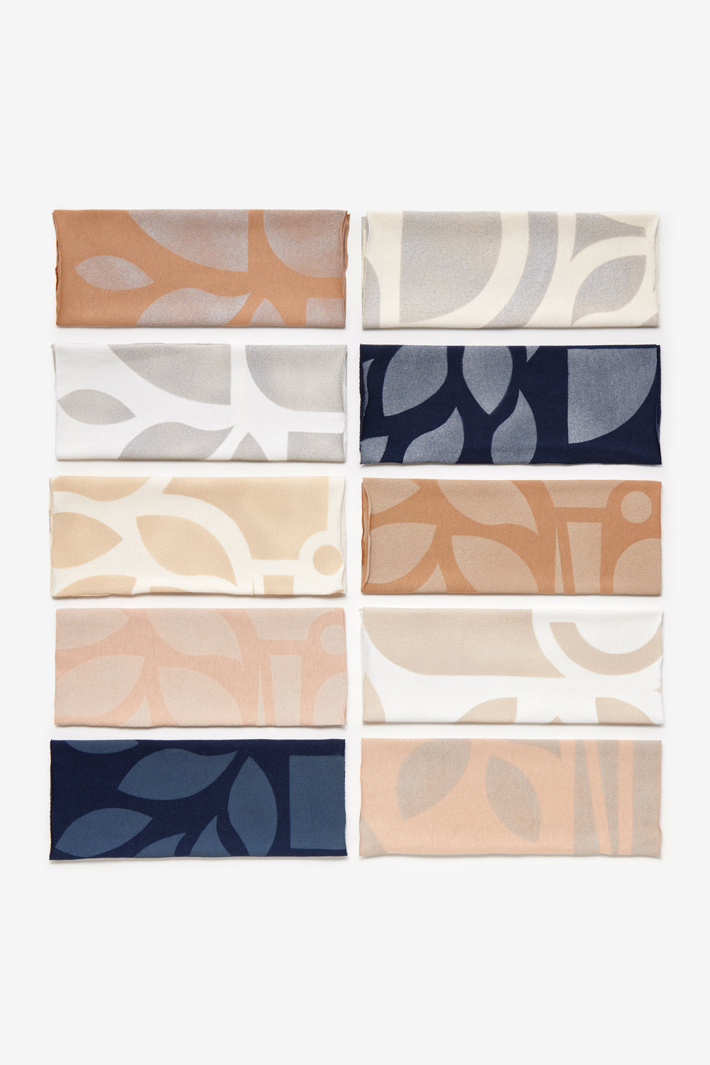 Fabric swatches in camel, white, natural, ballet, and navy with abstract stenciling.