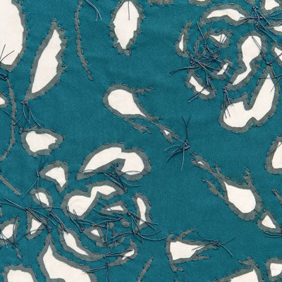 Reverse appliqué fabric swatch in teal on natural