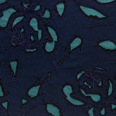 Reverse appliqué fabric swatch in navy on teal