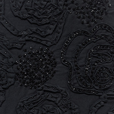 Fabric swatch featuring black fabric appliqué on black fabric.