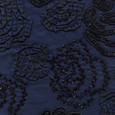 Fabric swatch featuring black fabric appliqué on navy fabric.