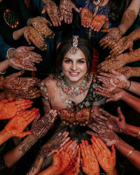 Woman Wearing Traditional Clothing and Mehendi Posing under a Garland ·  Free Stock Photo