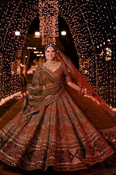 Photo of Bride posing in bright pink gota patti lehenga