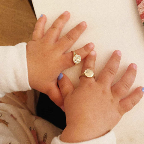 baby hands with solid gold rings