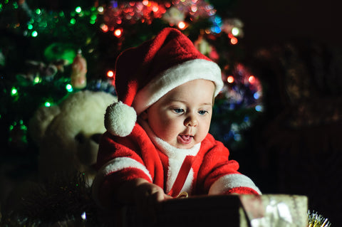 Baby in snta outfit with present