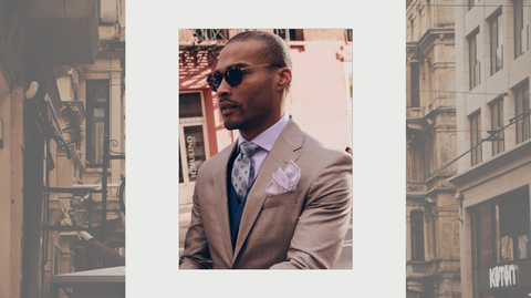 image of male model wearing joseph abboud sunglasses over an image of a city 