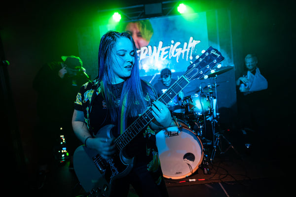 Luana TG playing guitar with Paperweight