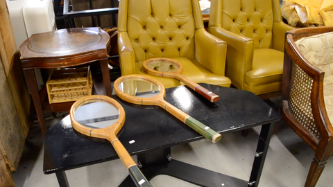 Tennis racket mirrors and vintage yellow chairs