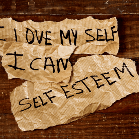 paper on top of a table that says self-esteem