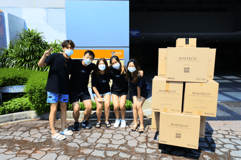 Photograph taken in front of NUS Business School with Wistech mask boxes and Shiora box
