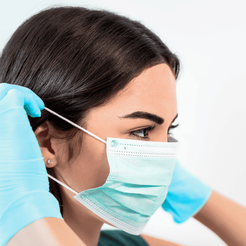 nurse putting on a mask