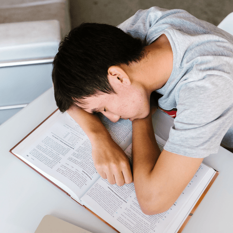 guy sleeping on a book 