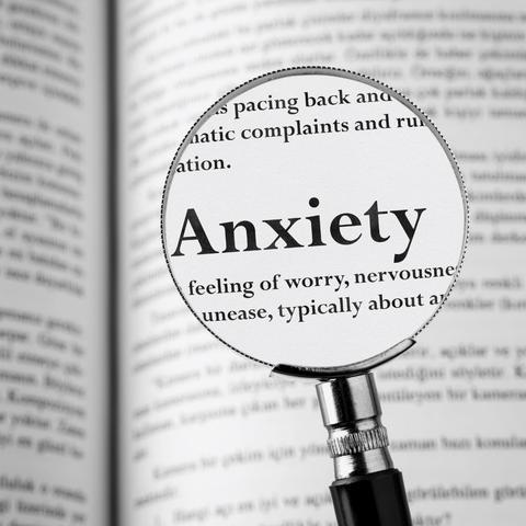 magnifying glass showing the word anxiety