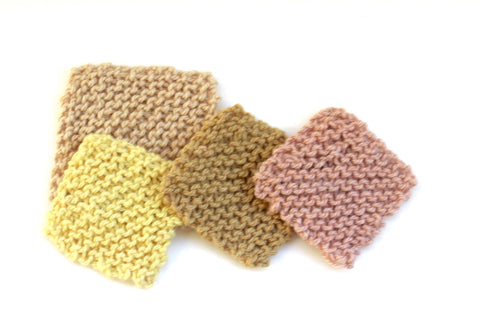 Swatches of plant dyed hand knitted squares