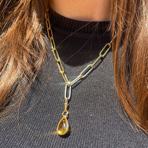 Citrine enhancer on a paper clip chain on a woman
