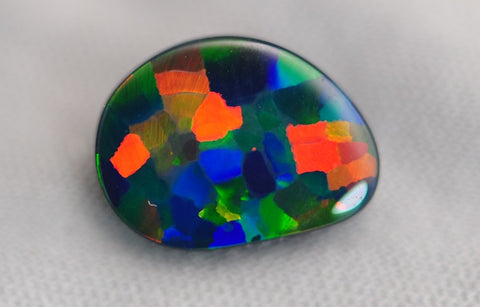 An example of a black opal with a rare harlequin colour pattern. Image courtesy of Cody Opal.
