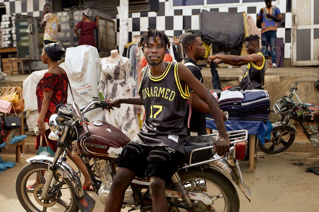 Street vendors wearing Unarmed jerseys in Lapaz, Ghana