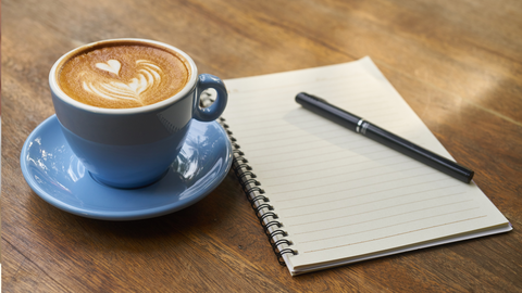 Best morning routines that help you lessen your screen time. Warm morning drink and a journal.