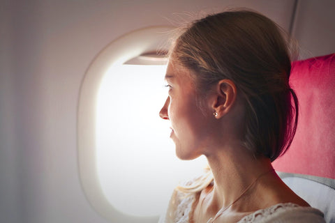 Girl looking out of the flight window