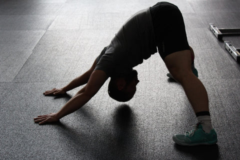 Guy stretching in gym 