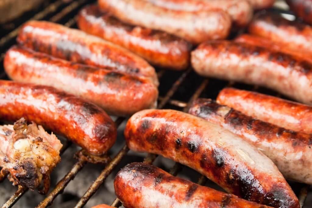 Sausages Cooking On A Grill