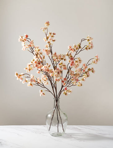 artificial blossom in balloon vase