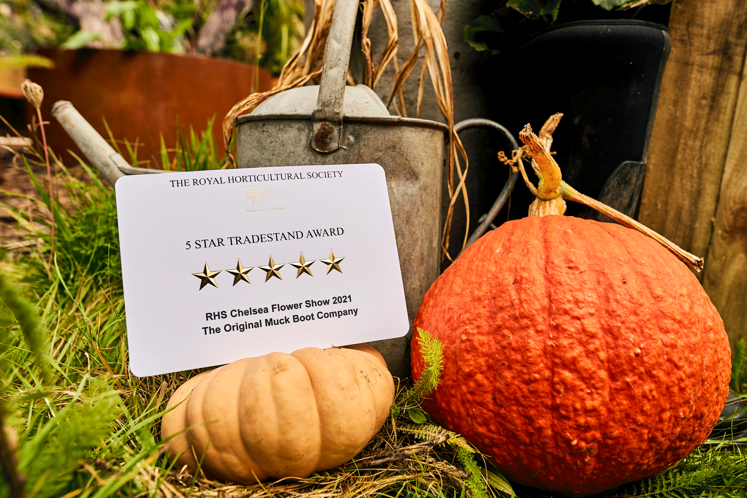 Pumpkin, rhubarb and a watering can underneath a 5 star award for Muck Boot