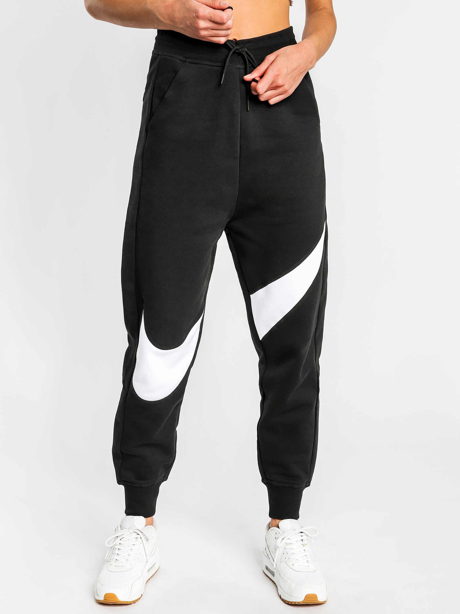 swoosh track pants