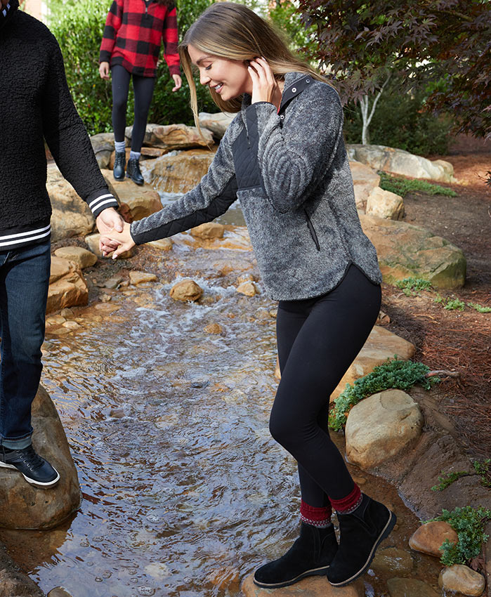 women in pullover and leggings