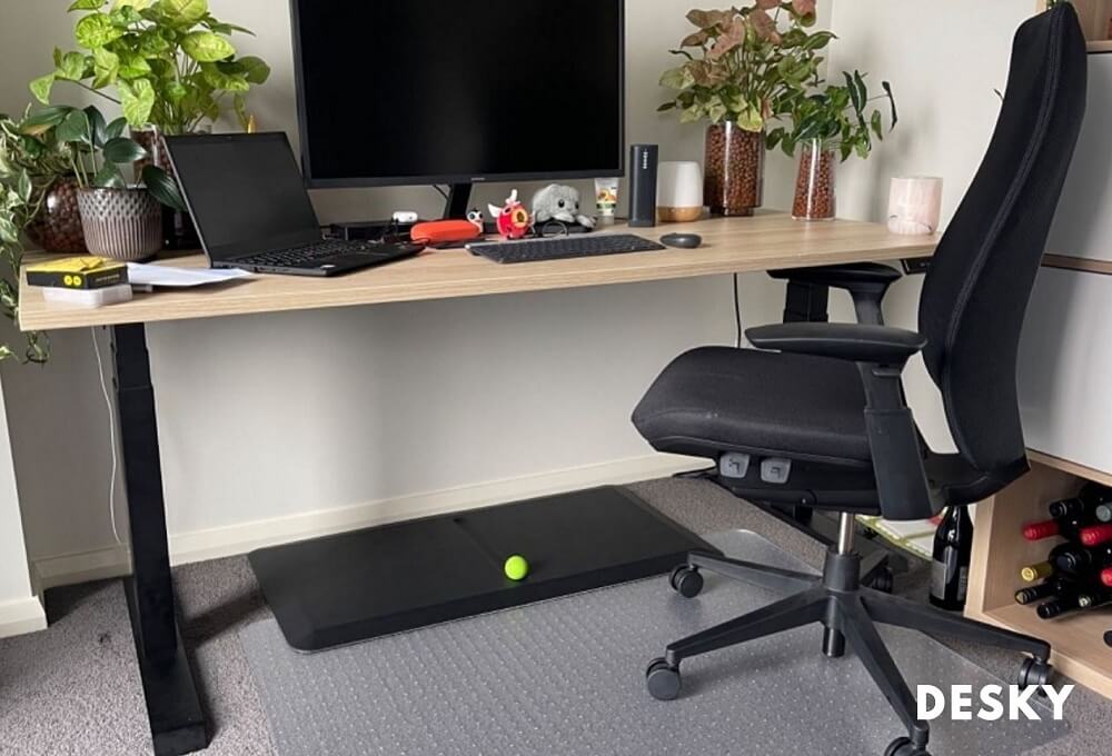 Sit stand desk with a mat pad for foot rest