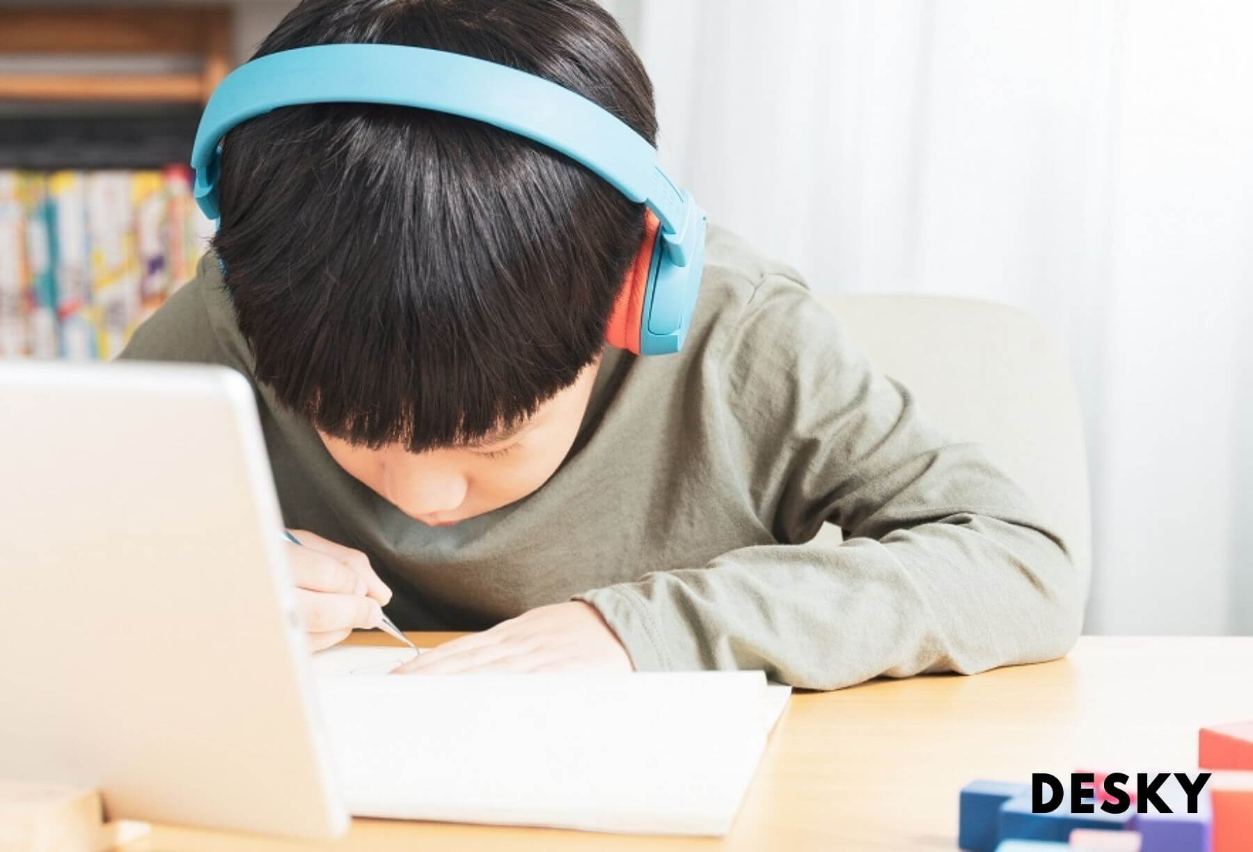 A boy sitting on his computer for learning