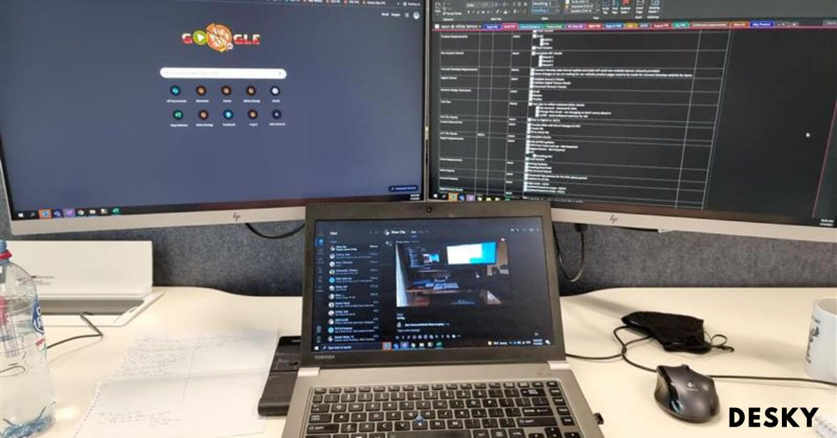 Two monitors and a laptop desk setup