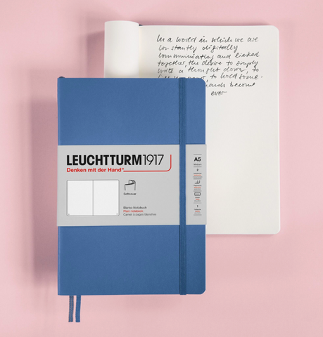 Leucctturm 1917 journal in bright blue, on a pink background.