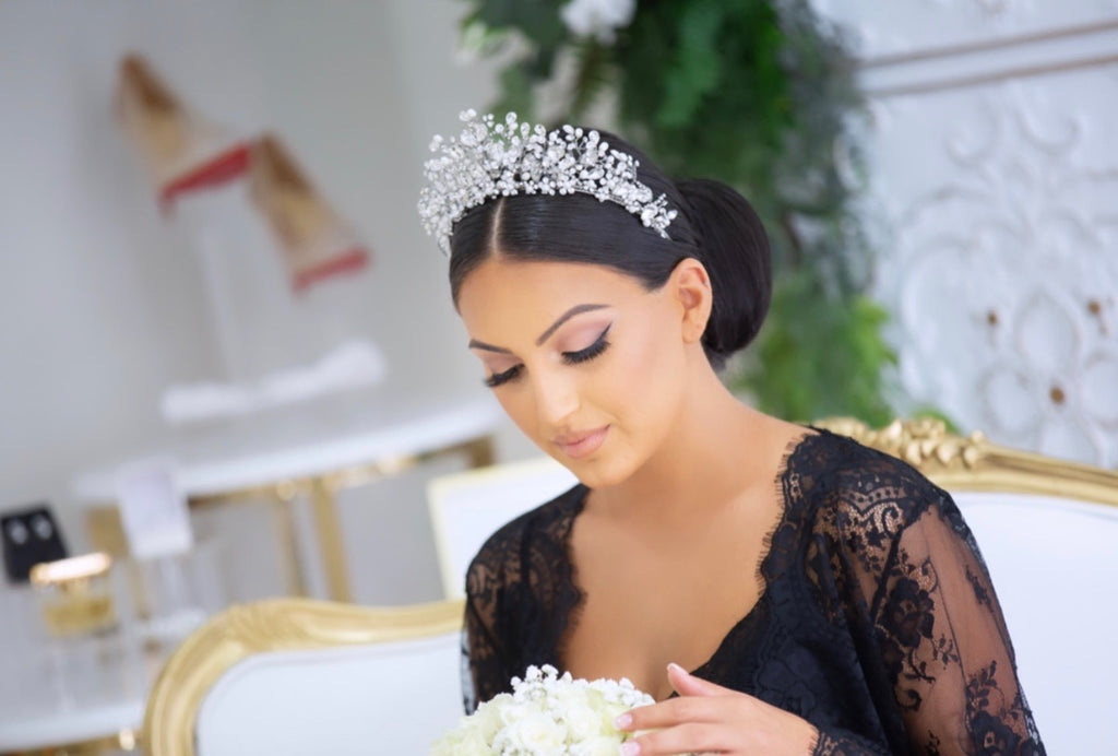 Georgette wearing our Katrina Bridal Crown looking down at her bouquet