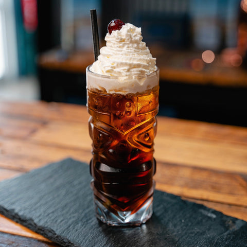 Boozy Cola Float Cocktail Recipe. Cola Vodka Coke Float cocktail served in a tiki glass with ice cream and cherry on top. Newy Distillery cocktails.