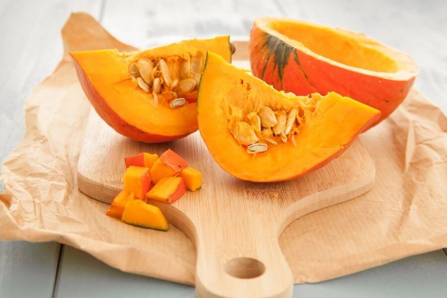 pumpkin cut up with seeds showing