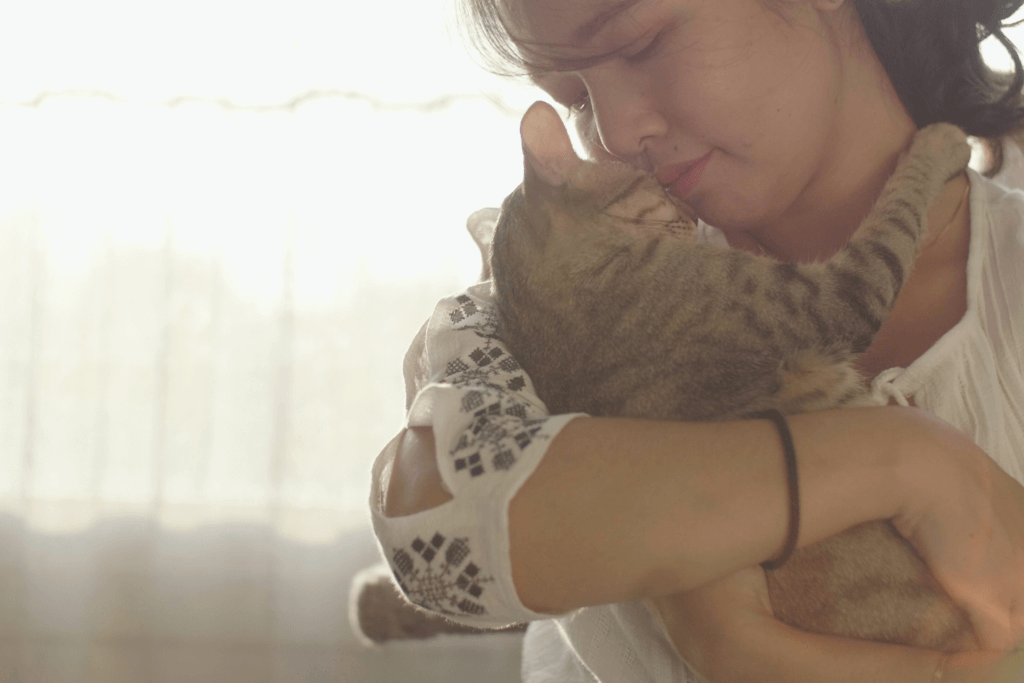 woman holding cat close to face