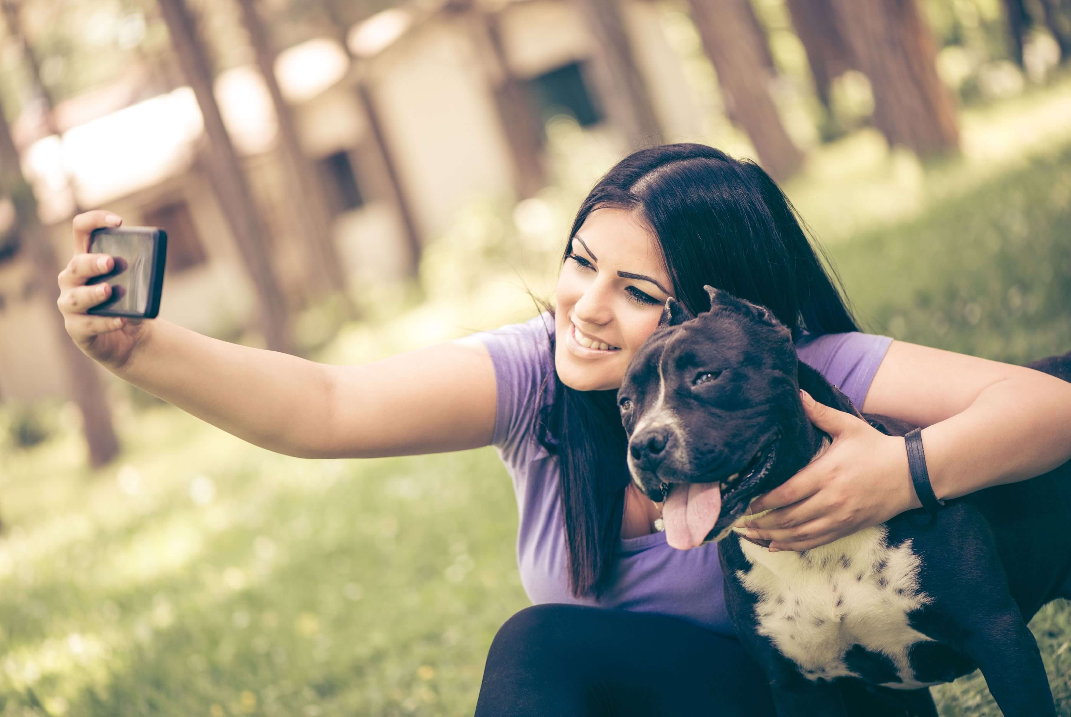 woman taking selfie with dog