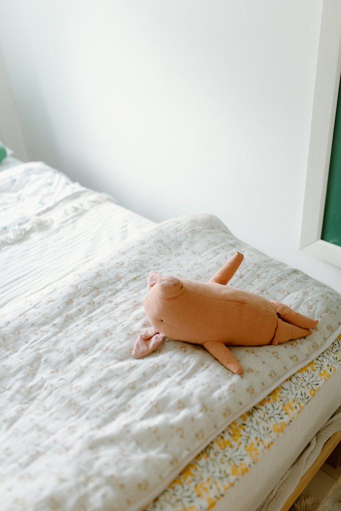 Dainty floral toddler quilt with pig stuffed animal