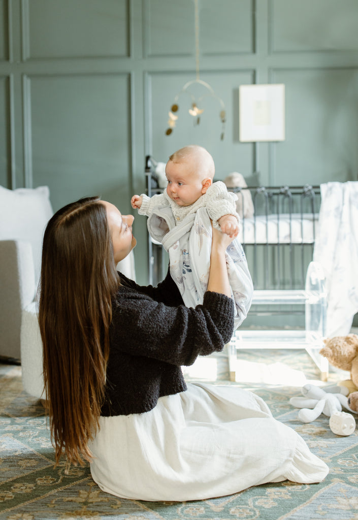 woman holding baby in Oilo cottontail swaddle blanket