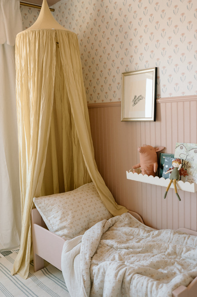toddler bed with canopy and wall art