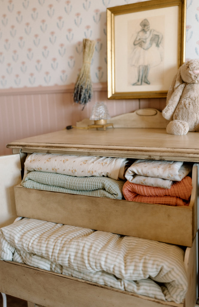 dresser with bedding inside