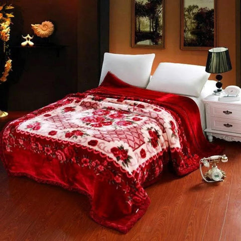 A classic bedroom with a red comforter.